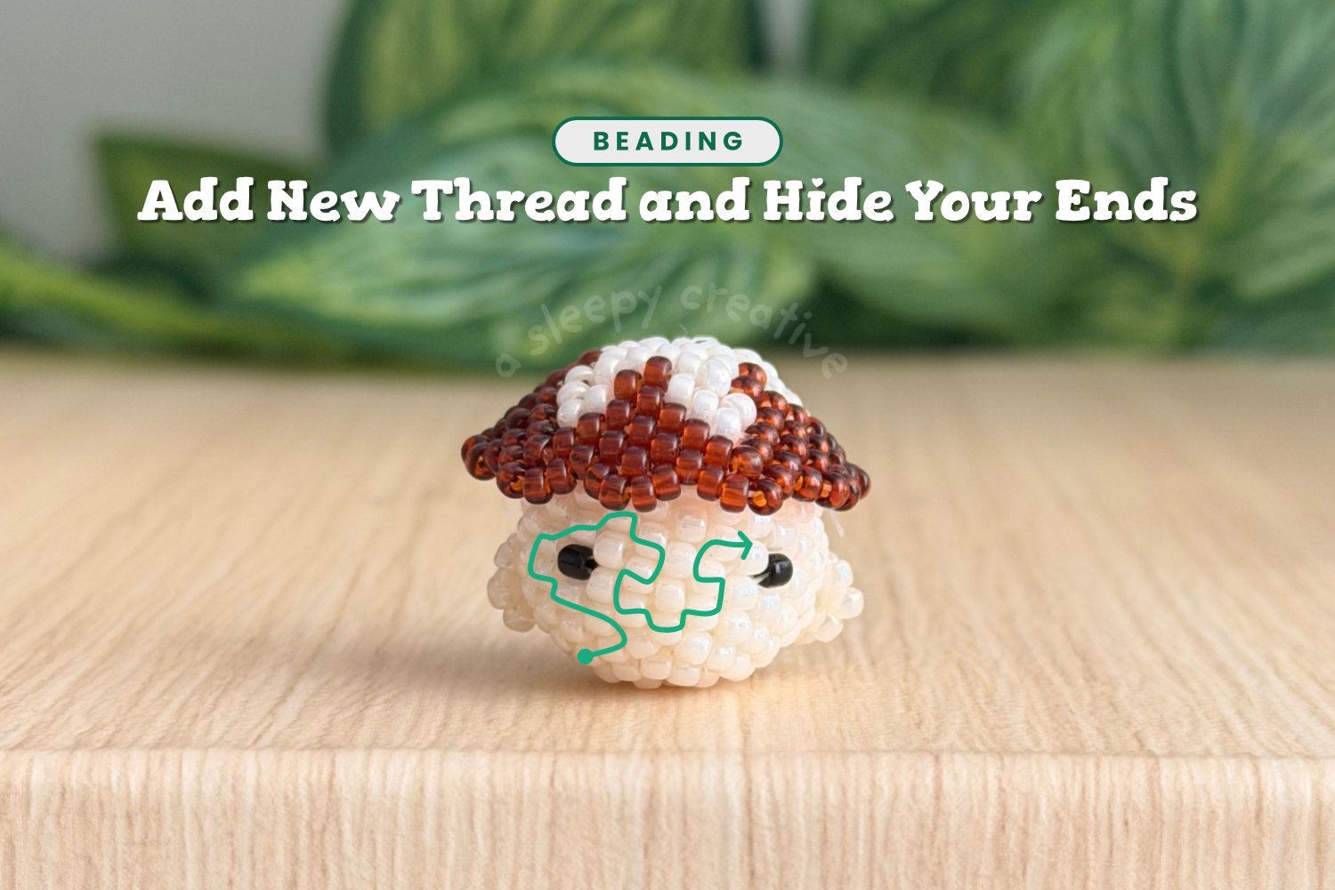 3D beaded mushroom with a brown cap and a green line showing how to weave in a new thread and hide your ends in beading